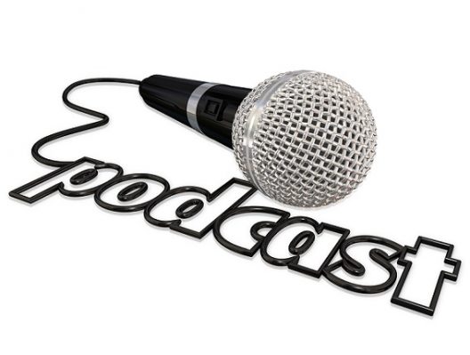 Podcast word spelled in a black cord attached to a microphone fo