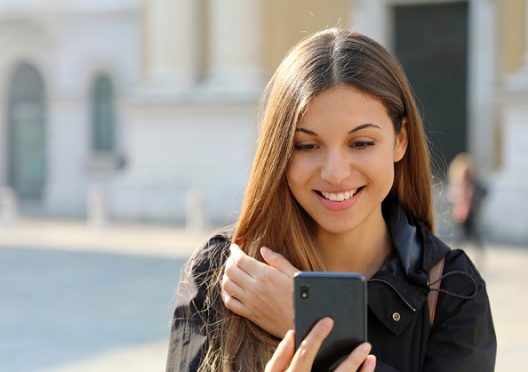 excited-beautiful-young-woman-reading-good-news-on-smart-phone-o