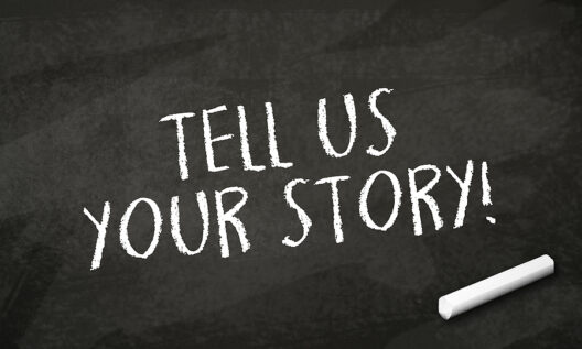 black-chalkboard-with-message-tell-us-your-story